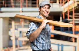 Builder's Risk Man Holding Piece of Wood