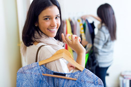 Clothing Stores Woman Holding Shirt on Hanger